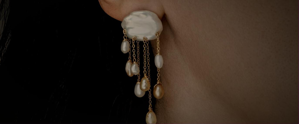 Handmade Adorn Pili earring with a baroque pearl and gold chain pearl drops worn on the ear
